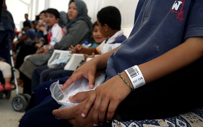  Refugees and migrants wait for a pre-registration process at the refugee camp in the former international Helliniko airport in Athens, Greece, 13 June 2016 (EPA Photo)