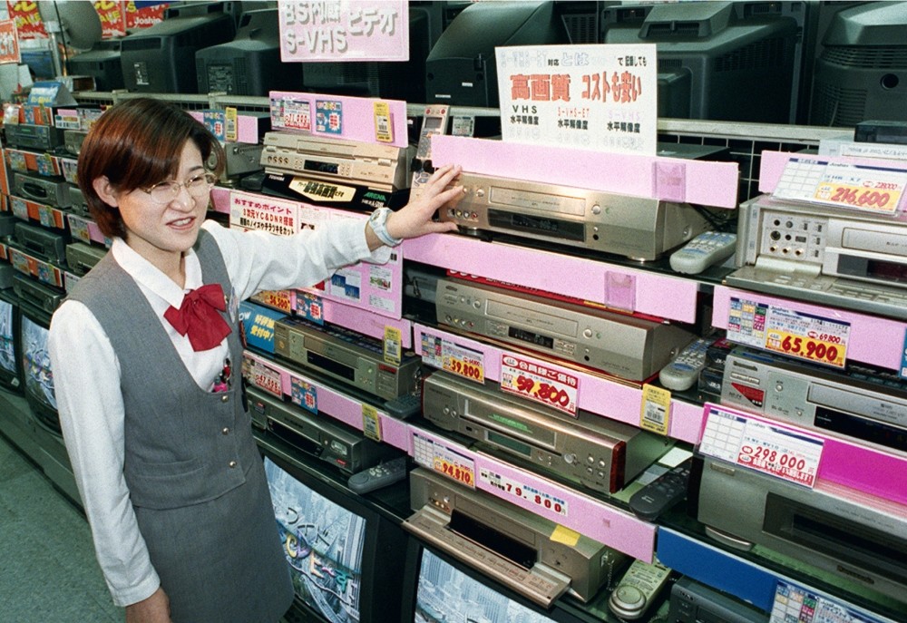In this Oct. 31, 1998 photo, a salesclerk shows high quality VHS video casette recorders at a home and electrical appliance store in Osaka.
