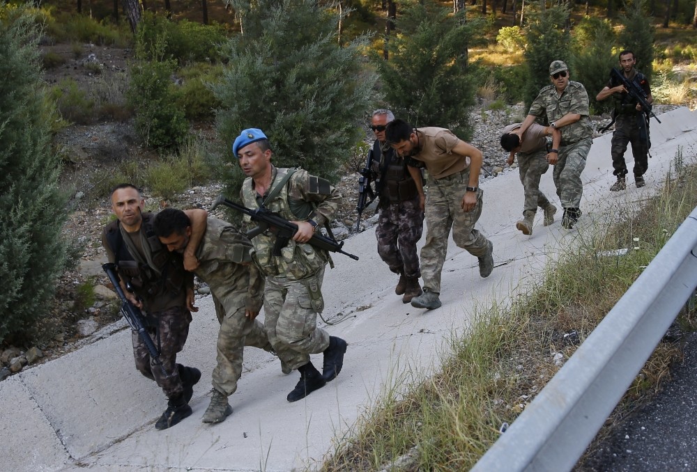 Soldiers and members of police's special forces unit accompany officers linked to the Gu00fclenist junta after their capture near the southwestern town of Marmaris last month.