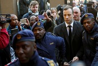 Olympic and Paralympic track star Oscar Pistorius is escorted by police officers as he arrives for his sentencing for the 2013 murder of his girlfriend Reeva Steenkamp, at North Gauteng High Court, Pretoria, S. Africa, July 6, 2016. (Reuters Photo)