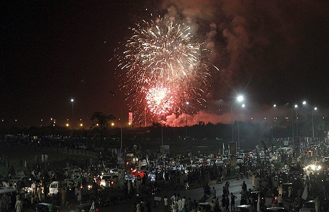 Pakistan people gather to watch a firework display during Pakistan Independence Day celebrations in Islamabad, Pakistan, Sunday, Aug. 14, 2106. (AP Photo)