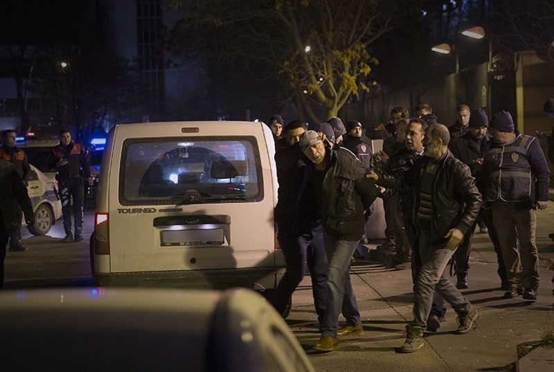 Police detain the man who opened fire into the air outside the US embassy in Ankara. (AA Photo)