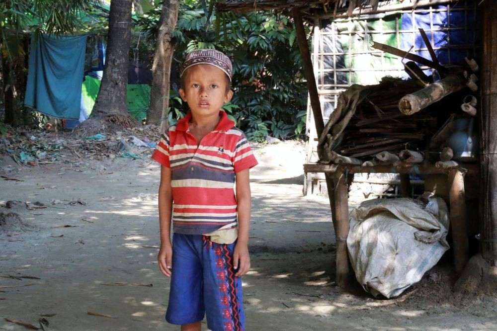 A Muslim boy stands in front of a house in Maungdaw, a town located in Myanmar's strife-torn Rakhine State near the Bangladesh border on Dec. 2.