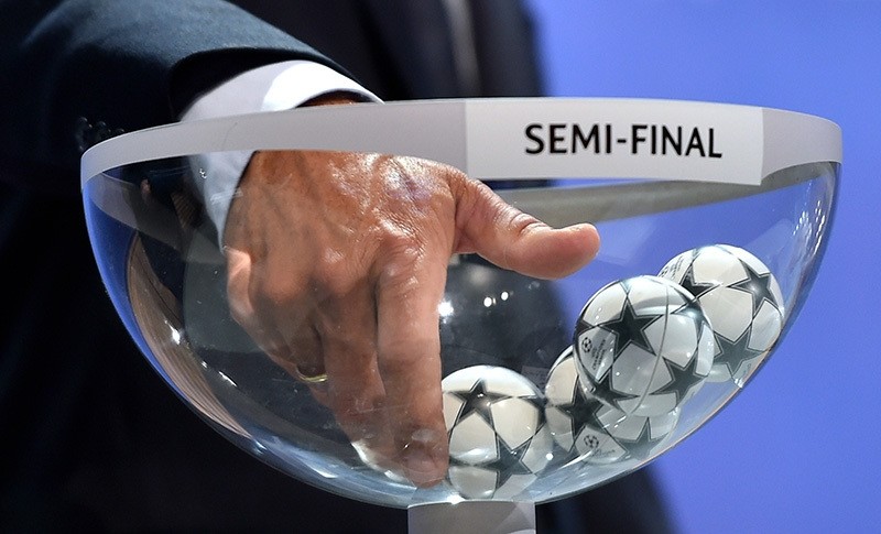 This file photo shows ambassador for the UEFA Champions League final in Berlin Karl-Heinz Riedle picks up a drawing ball during the draw for the UEFA Champions League semi-final matches at the UEFA headquarters in Nyon on April 24, 2015. (AFP Photo)
