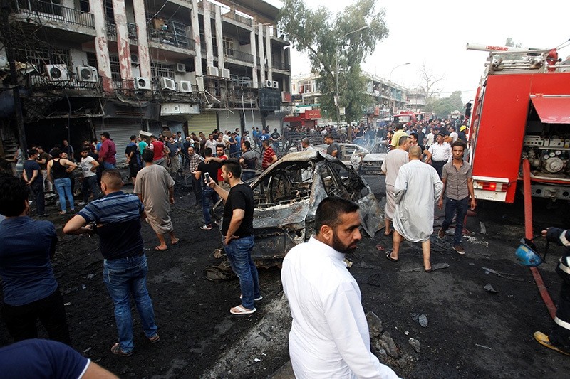 People gather at the site of a suicide car bomb in the Karrada shopping area, in Baghdad, Iraq, July 3, 2016. (Reuters Photo)
