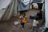 A little girl running among tents at Ritsona refugee camp, which hosts about 600 refugees and migrants, north of Athens, Sept. 12, 2016.