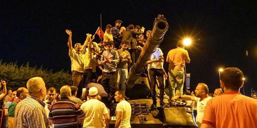People stand on an abandoned tank and cheer after the failed coup attempt, in Istanbul.