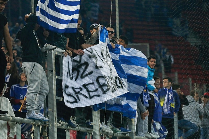 Greek fans raise banner displaying ,Knife, wire, Srebrenica, (Noz, zica, Srebrenica) during the soccer match against Bosnia and Herzegovina. Nov. 13, 2016. (AA Photo)