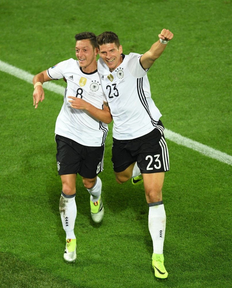 Mesut u00d6zil (L) and Mario Gomez celebrate goal against Italy.