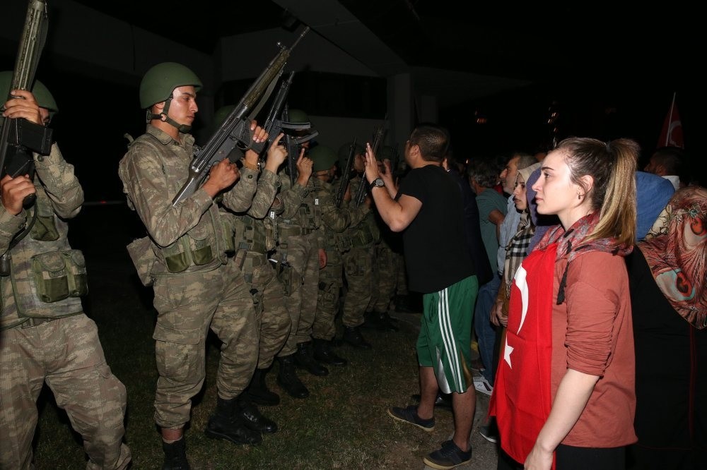 People confront pro-coup soldiers outside TRT headquarters on the coup night. The coup plotters held the public broadcaster's employees hostage for hours before security forces regained control.