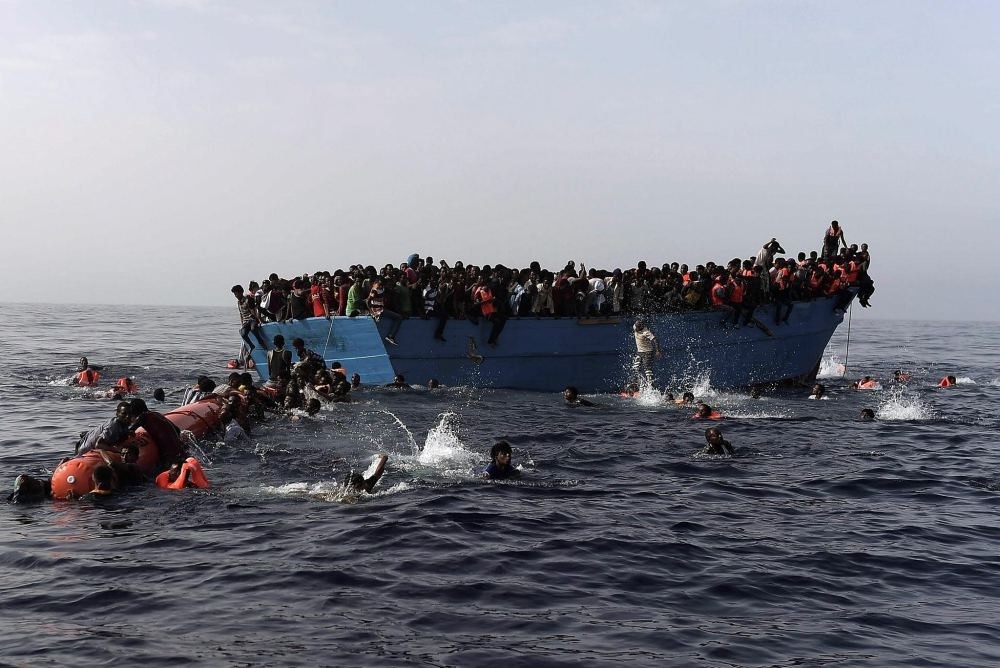 Migrants wait to be rescued in the Mediterranean Sea, some 12 nautical miles north of Libya, on Oct. 4.