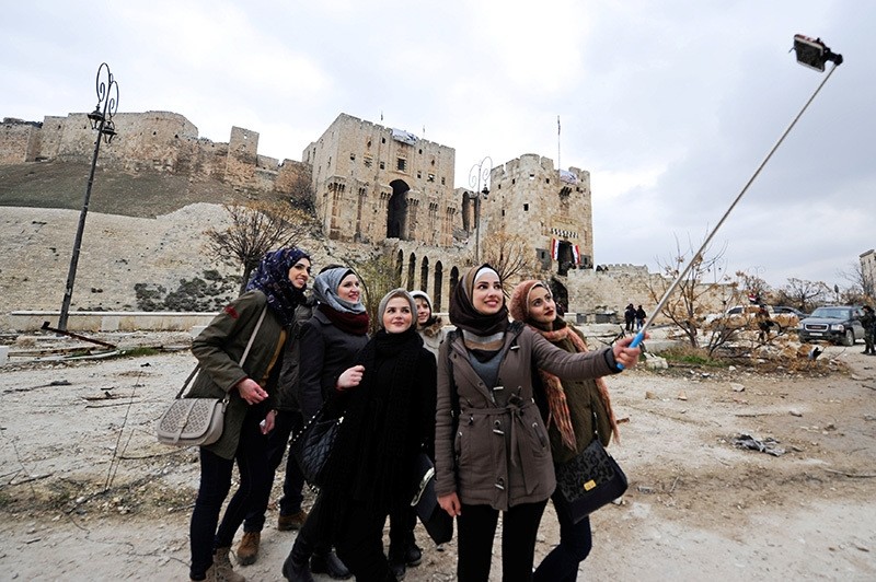 Women take a selfie outside Aleppou2019s historic citadel, Syria, Dec. 17, 2016. (Reuters Photo)