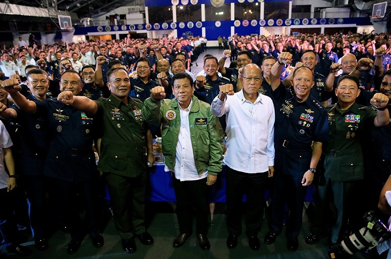 President Rodrigo Duterte (C) clenches fist while wearing a Blue Bird jacket given by the Philippine Air Force (PAF) during the 250th Presidential Airlift Wing (PAW) anniversary  September 13, 2016. (Reuters Photo)