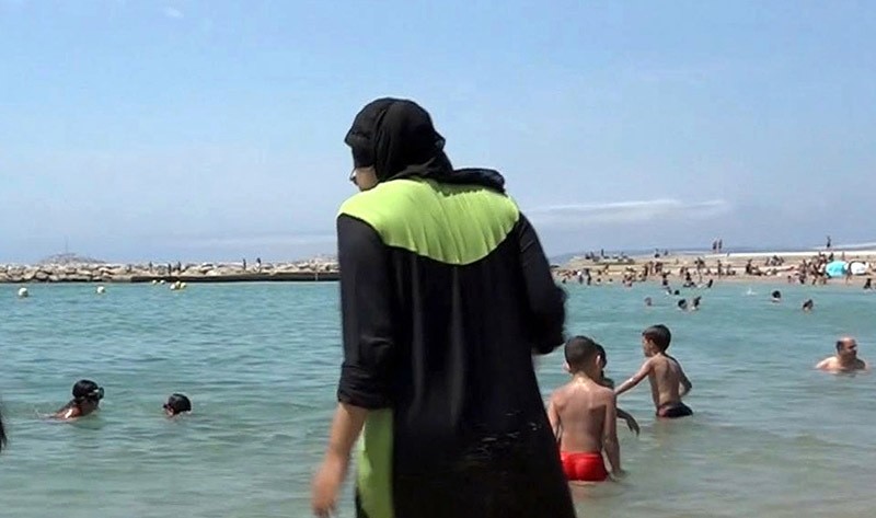 n this Aug. 4 2016 file photo made from video, Nissrine Samali, 20, gets into the sea wearing a burkini, a wetsuit-like garment that also covers the head, in Marseille, southern France (AP Photo)