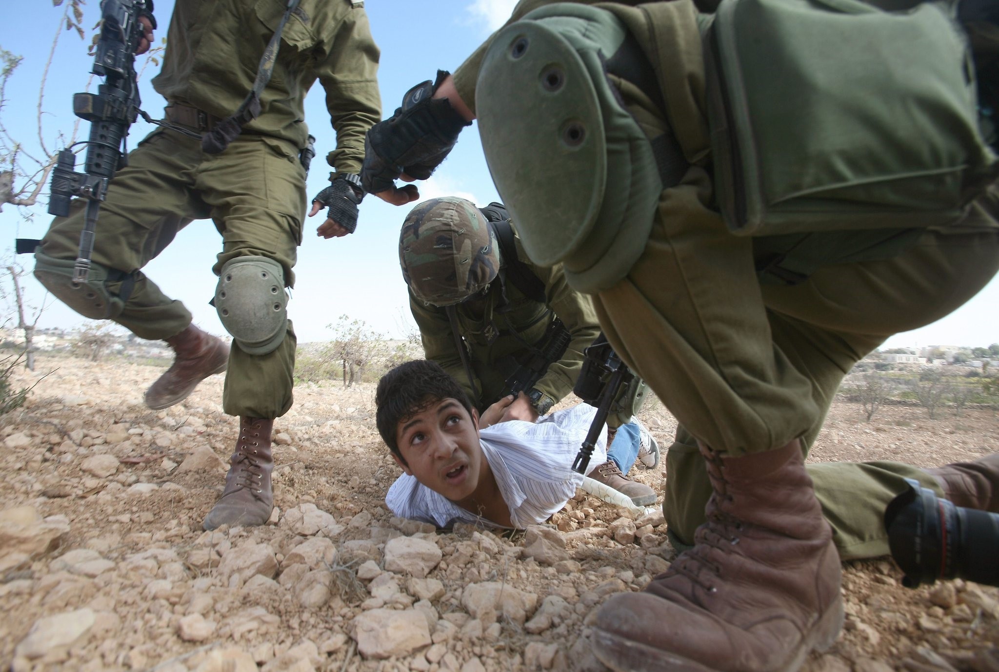 An October 23, 2010 file photo shows Palestinian youth is arrested by Israeli soldiers. (AFP Photo)
