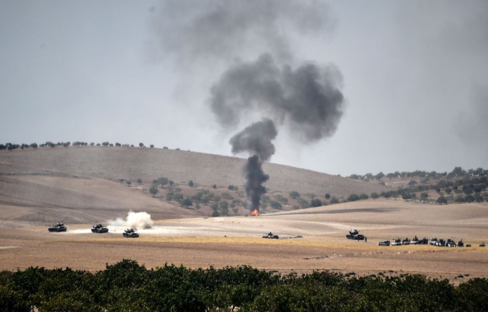 Turkish army tanks and alleged Syrian moderate fighter trucks positioned 2 kilometres west from Jarablus the Syrian town on the border with Turkey, preparing to move position, to Karkamu0131u015f in Turkey's southeastern Gaziantep province, Aug. 24.