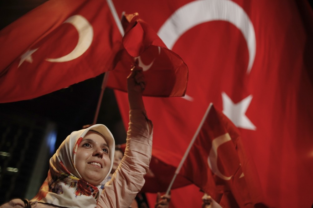 A woman waves a Turkish flag during a rally against the attempted coup in Taksim Square, Istanbul.