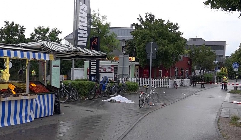 In this grab taken from video, a body covered with a sheet outside the mall, in Munich, Germany, Friday, July 22, 2016 (AP Photo)