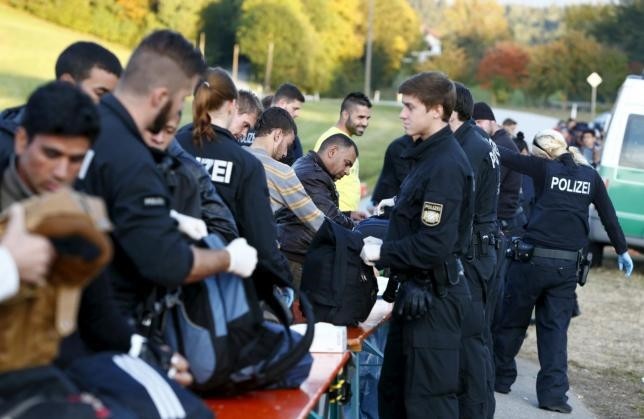Migrants are controlled by German police officer near Breitenberg, south eastern Germany, October 5 (Reuters Photo)