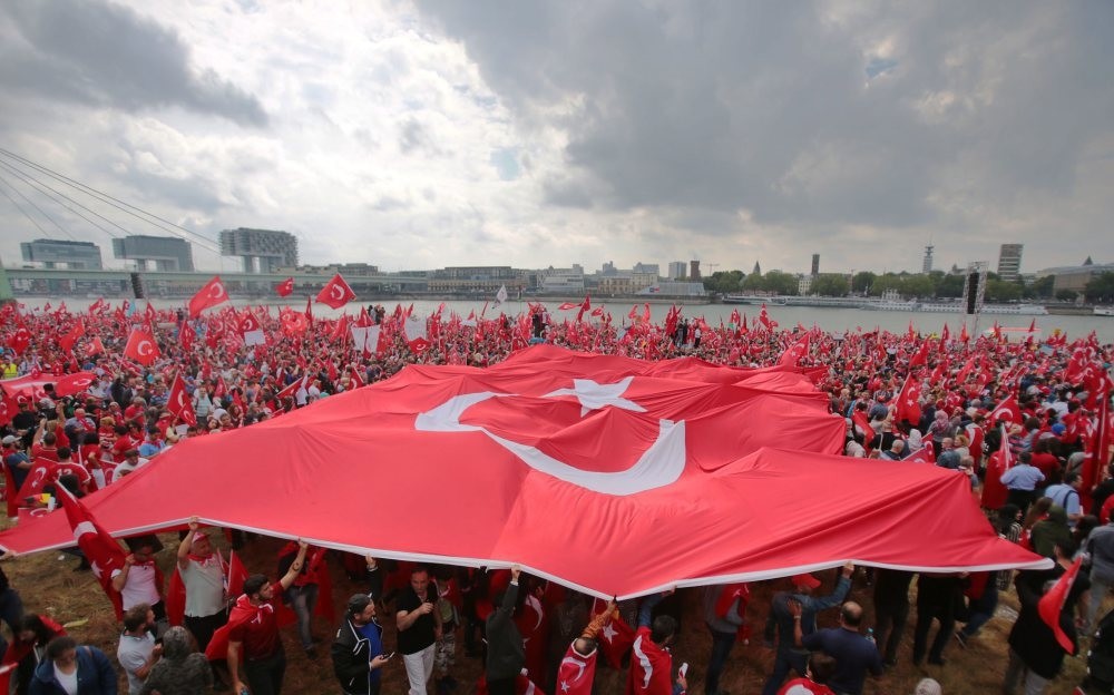People waving  flags at a pro-democracy rally against the failed coup attempt, Cologne, Germany, July 31.