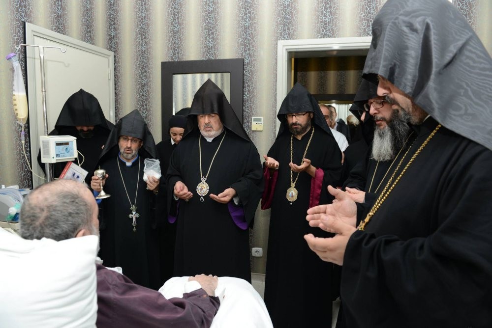 Bishops gather around Patriarch Mesrob II at his hospital room. Mesrob II has been in a vegetative state since 2008.