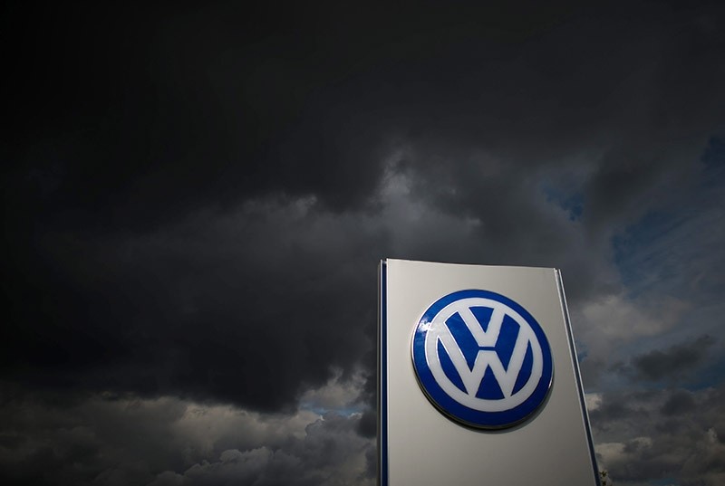 Dark clouds above a corporate logo of German car manufacturer Volkswagen in front of the Volkswagen plant in Wolfsburg, Germany. (EPA Photo)