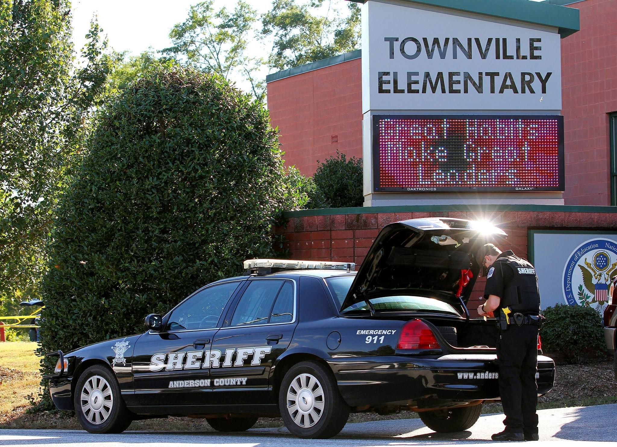 An Anderson County sheriffu2019s deputy stands outside of Townville Elementary School after a shooting in Townville, South Carolina, Sept. 28.