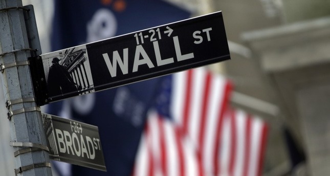 File photo shows a Wall Street sign adjacent to the New York Stock Exchange.