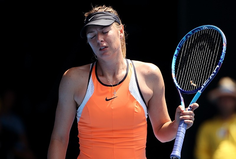 In this Tuesday, Jan. 26, 2016 file photo, Maria Sharapova of Russia reacts after losing a point to Serena Williams of the United States during their quarterfinal match at the Australian Open tennis championships in Melbourne (AP Photo)