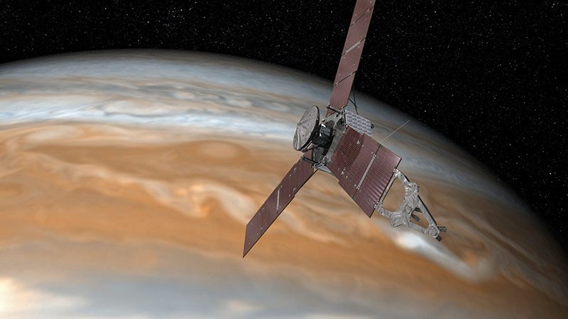 An undated handout image made available by NASA on 16 June 2016 shows an artist's rendering of NASA's Juno spacecraft making one of its close passes over Jupiter. (EPA)