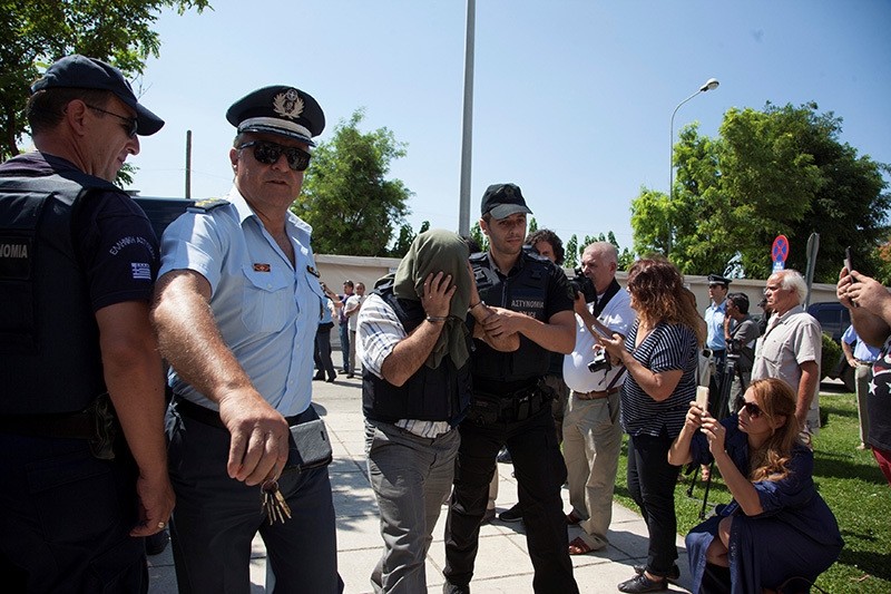One of the 8 Turkish soldiers who fled to Greece in a helicopter and requested political asylum after a failed military coup against the government, is escorted to courthouse of the n. city of Alexandroupolis, Greece, July 21, 2016. (Reuters Photo)