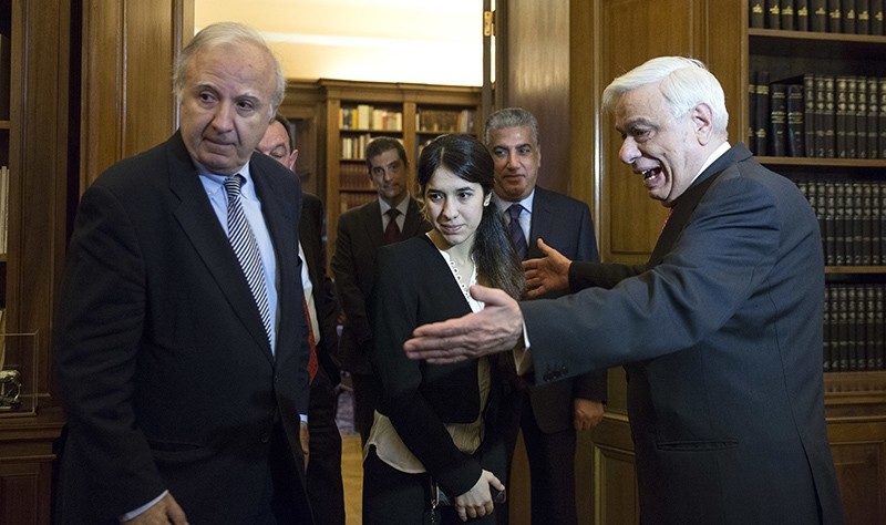 In this Dec. 30, 2015 file photo, Iraqi Yazidi Nadia Murad Basee, center, is welcomed by Greek President Prokopis Pavlopoulos, right, before their meeting in Athens (AP Photo)