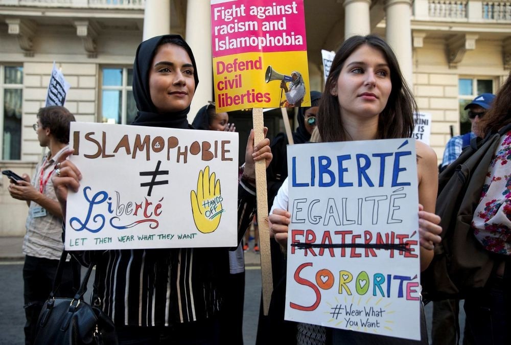 Women join a demonstration organized by ,Stand up to Racism, outside the French Embassy in London on Aug. 26 against the Burkini ban on French beaches.
