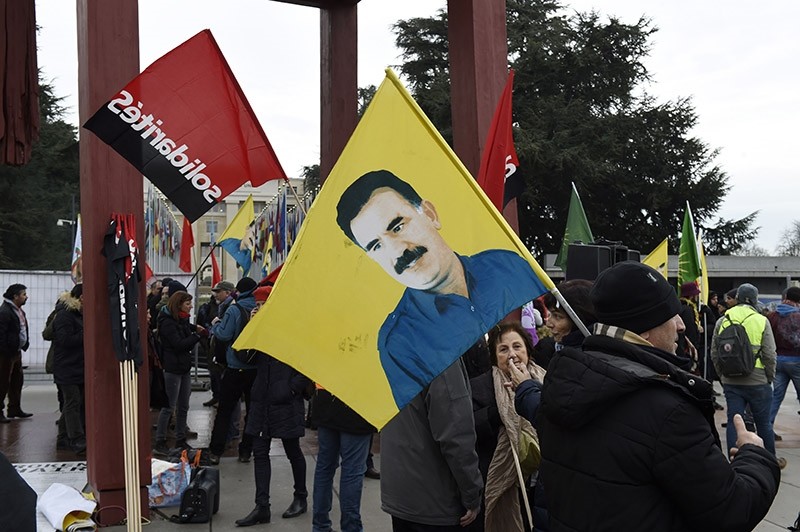 Pro-PKK demonstrators hold a flag with the image of jailed PKK leader Abdullah u00d6calan in a rally in front of the U.N. headquarter building in Geneva, Switzerland on Jan. 12, 2017. (AFP Photo)