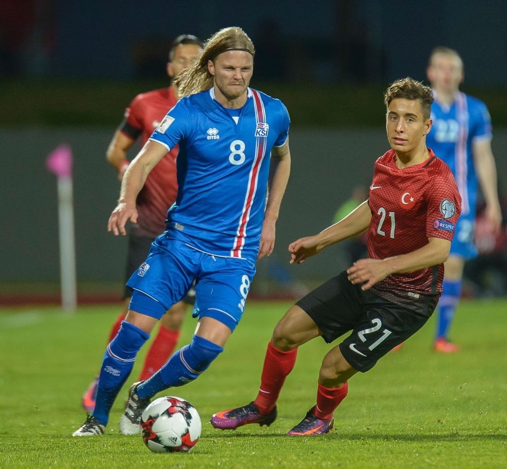 Icelandu2019s midfielder Birkir Bjarnason (L) and Turkeyu2019s forward Emre Mor vie for the ball during the 2018 World Cup qualifier football match of Iceland vs Turkey in Reykjavik.