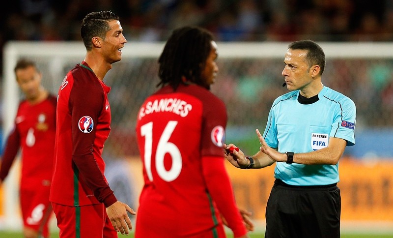 Cristiano Ronaldo (L) of Portugal argues with Turkish referee Cuneyt Cakir (R) during the UEFA EURO 2016 group F preliminary round match between Portugal and Iceland at Stade Geoffroy Guichard in Saint-Etienne, France, 14 June 2016.  EPA Photo