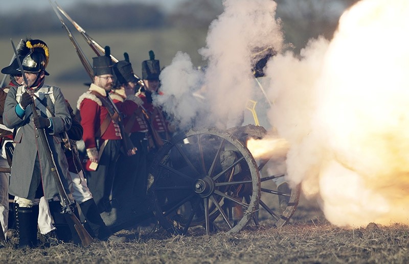 History enthusiasts dressed in regimental costumes fire a cannon as they take part in a re-enactment of Napoleon's famous battle of Austerlitz, celebrating its 211th anniversary near Slavkov u Brna, Czech Republic on Dec. 3, 2016. (AP Photo)