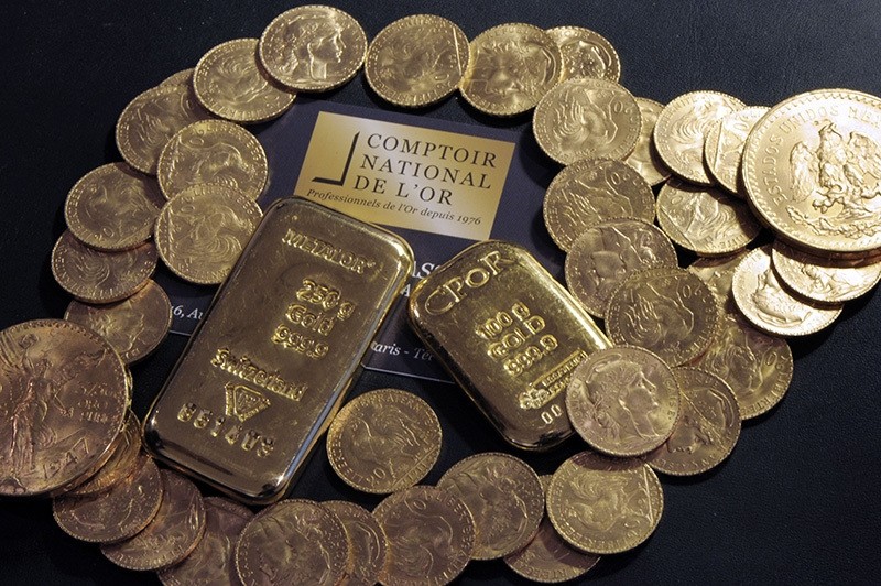 This file photo taken on October 05, 2012 shows Gold bars and coins displayed on a table at the Comptoir National de l'Or, a shop that buys, sales and estimates gold and jewellery in Paris. (AFP Photo)