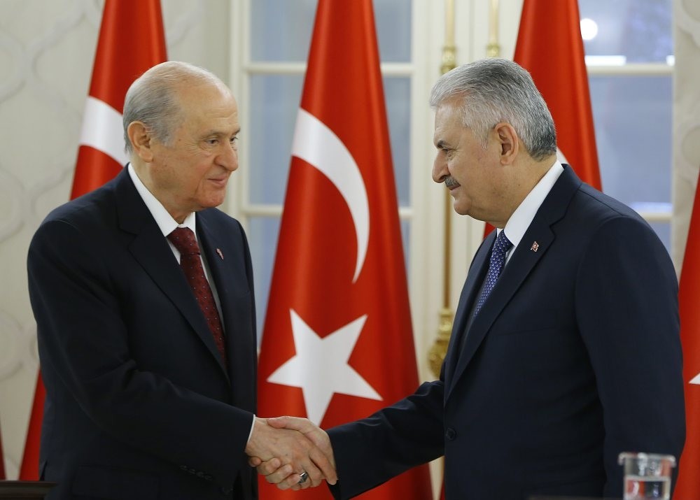 MHP leader Bahu00e7eli (L) shaking hands with Prime Minister Yu0131ldu0131ru0131m following a bilateral meeting to discuss the constitutional changes on Dec. 2.