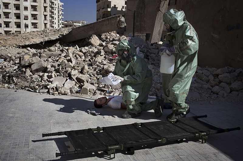 Volunteers take part in a simulation of how to respond to a chemical attack, in the northern Syrian city of Aleppo on September 15, 2013. (AFP)