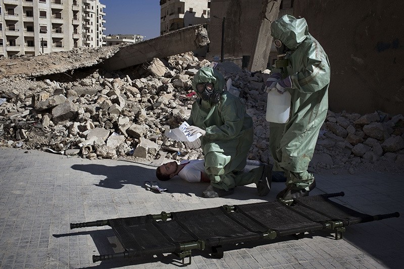 Volunteers take part in a simulation of how to respond to a chemical attack, in the northern Syrian city of Aleppo on September 15, 2013. (AFP)