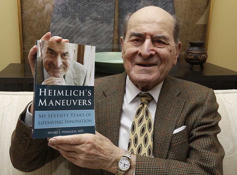 In this Feb. 5, 2014, file photo, Dr. Henry Heimlich holds his memoir prior to being interviewed at his home in Cincinnati. (AP Photo)