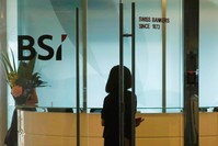 An employee enters the reception area of Swiss bank BSI's office in Singapore.