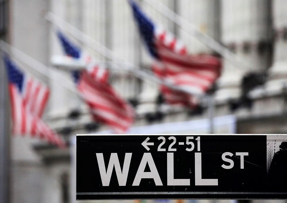 This April 22, 2010, file photo, shows a Wall Street sign in front of the New York Stock Exchange. (AP Photo)