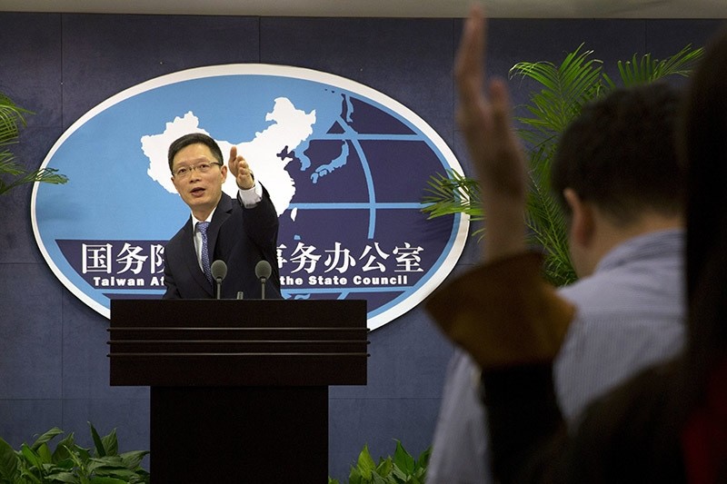 Taiwan Affairs Office spokesman An Fengshan signals for questions from a journalist at a routine press conference in Beijing, China on Wednesday, Dec. 14, 2016. (AP Photo)