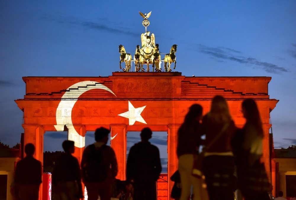 People looking at the Brandenburg Gate onto which a Turkish flag is projected to show a support for Turkey a day after the attacks at Istanbul's International Atatu00fcrk airport, Berlin, June 29, 2016.