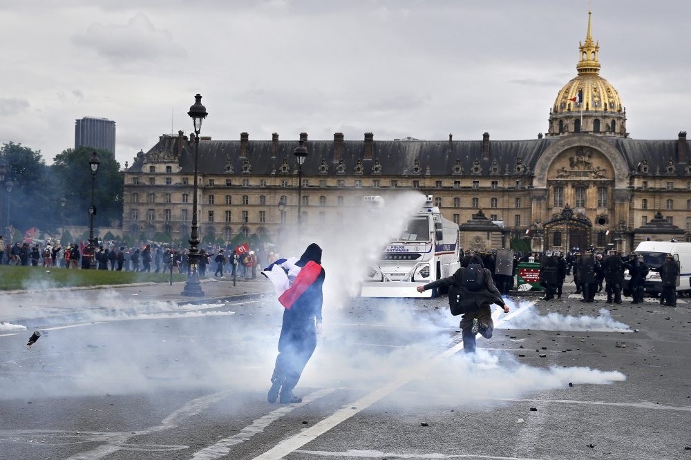 French riot police use water guns during clashes with protestors as part as a national demonstration and strike against the Labor Law reform in Paris.