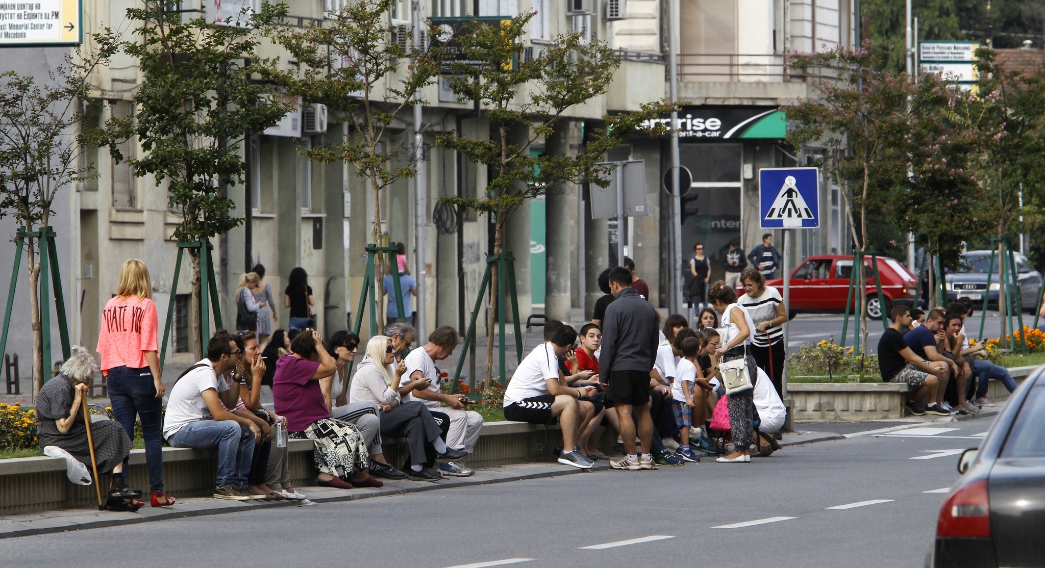 People sit in a street outside their homes, after an earthquake in Skopje, Macedonia, Sunday, Sept. 11, 2016. (AP Photo)