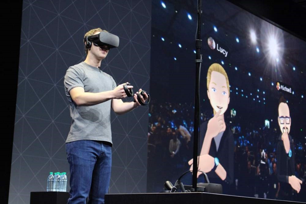 Facebook co-founder and chief executive, Mark Zuckerberg, speaks at an Oculus developers conference while wearing a virtual reality headset in San Jose, California.