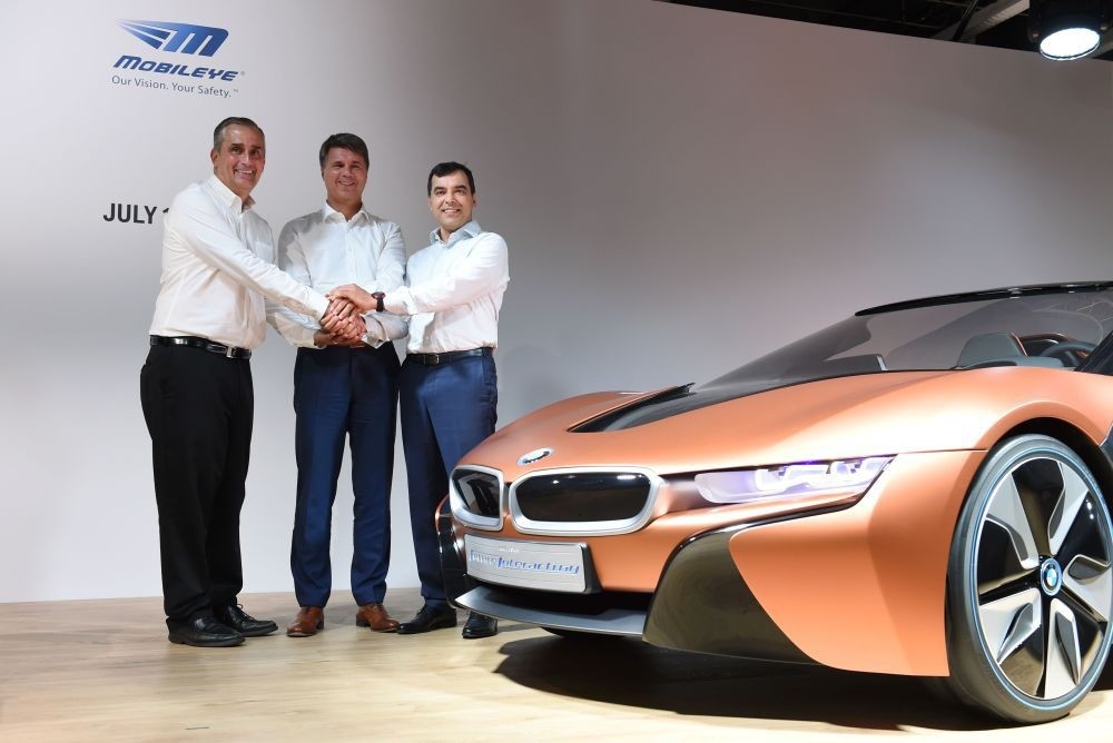 (L-R) Brian Krzanich, CEO of Intel, Harald Krueger, CEO of German car maker BMW and Amnon Shashua, co-founder, chairman and CTO Mobileye NV, pose after a press conference in Munich.
